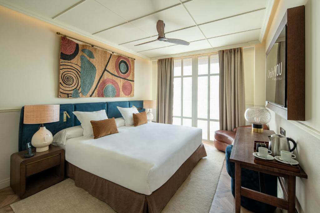 Stylish bedroom at Only YOU Hotel Sevilla, combining contemporary comfort with Andalusian charm and artistic wall décor