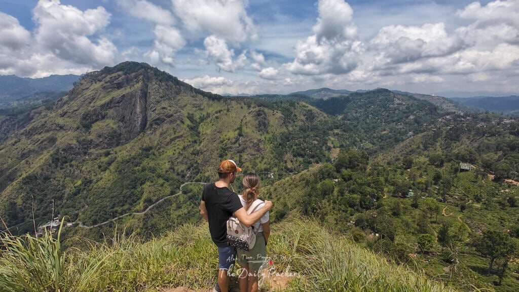 Couple admiring the green mountain landscape of Ella from a scenic viewpoint on Little Adam’s Peak