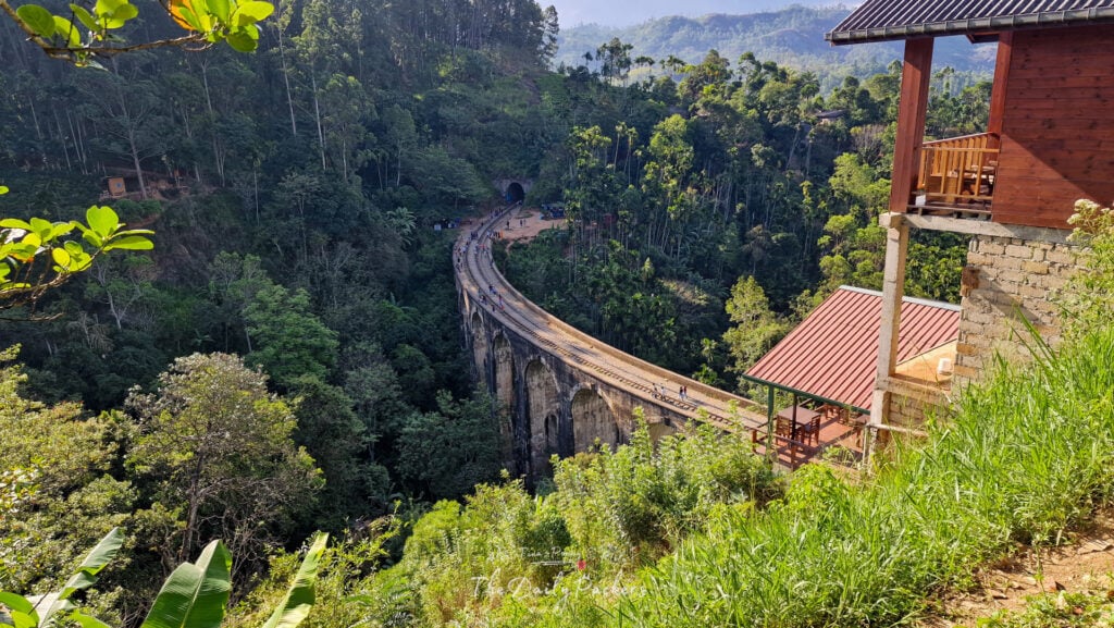 View of the Nine Arch Bridge from Asanka Café surrounded by lush green forest in Ella, Sri Lanka