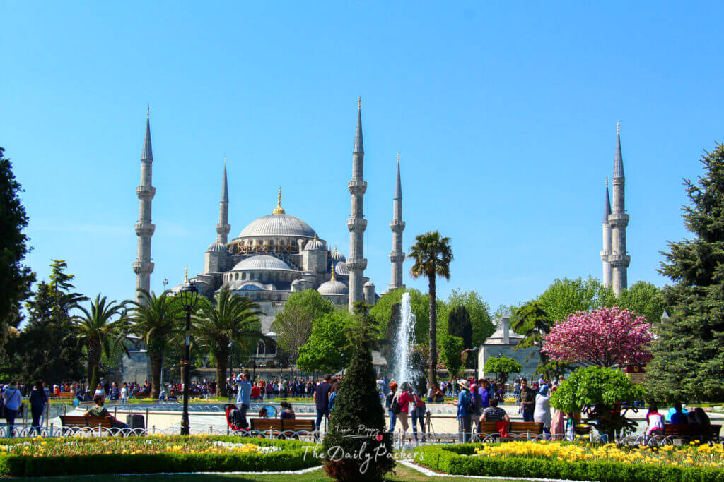 Sultanahmet Square in Istanbul on a sunny day with people walking near the iconic Blue Mosque.