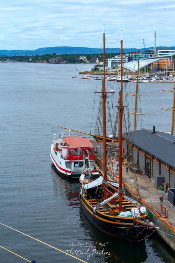 Bateaux colorés amarrés dans le port d'Oslo avec vue sur l'horizon de la ville.