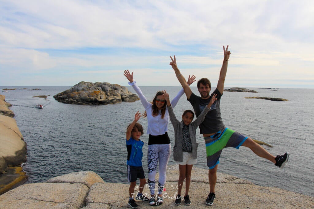 Friends jumping for a fun photo on the rocks at Verdens Ende.