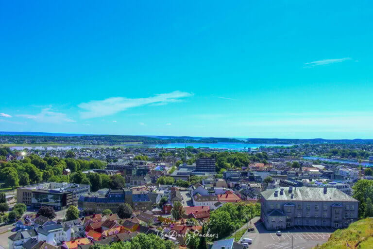 Panoramic cityscape of Tønsberg with the harbor and buildings under a clear blue sky.