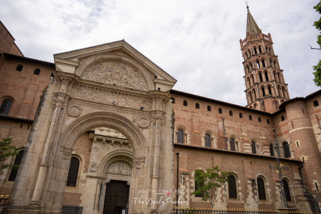 Entrance of the Basilica of Saint-Sernin showcasing its arched portal and richly detailed façade.