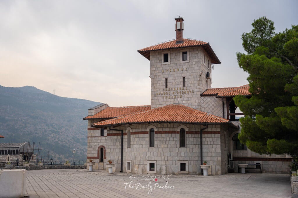 Hercegovačka Gračanica Monastery complex in Trebinje, featuring the main church building with red tiled roof and surrounding mountains.