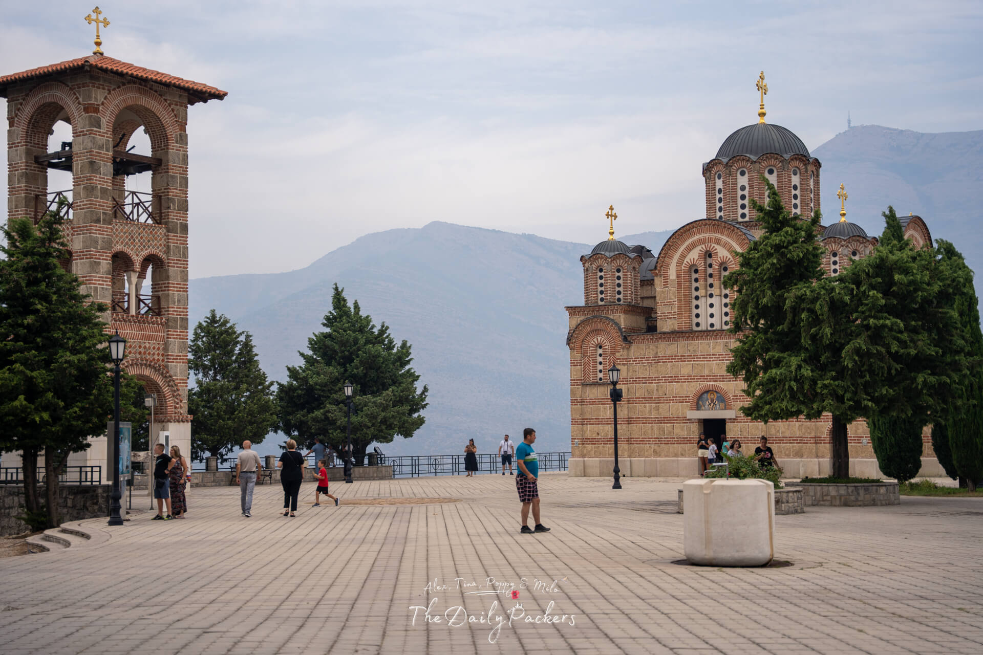 Hercegovačka Gračanica Church and bell tower set on a panoramic viewpoint overlooking the Trebinje valley and distant hills.