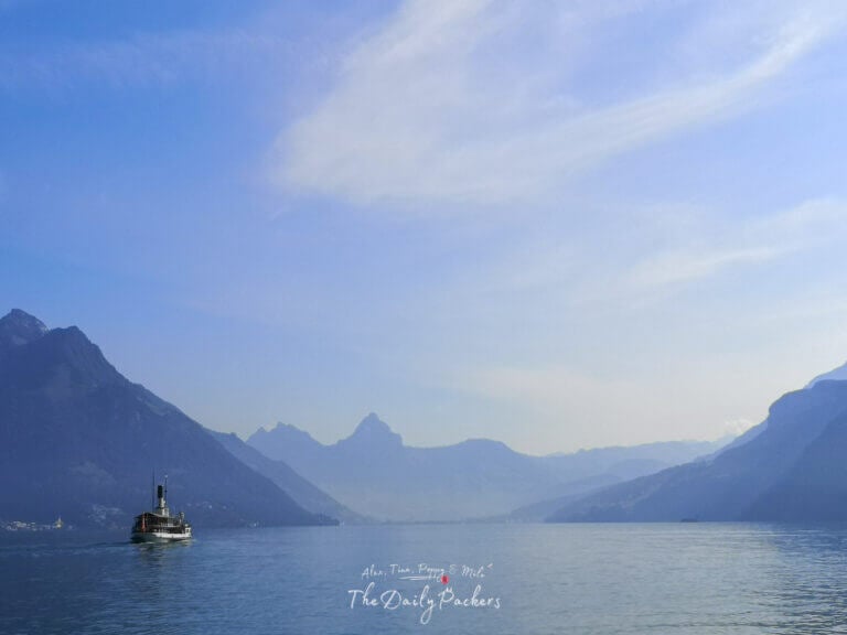 Steamboat crossing Lake Lucerne with mountains in the background on a sunny day