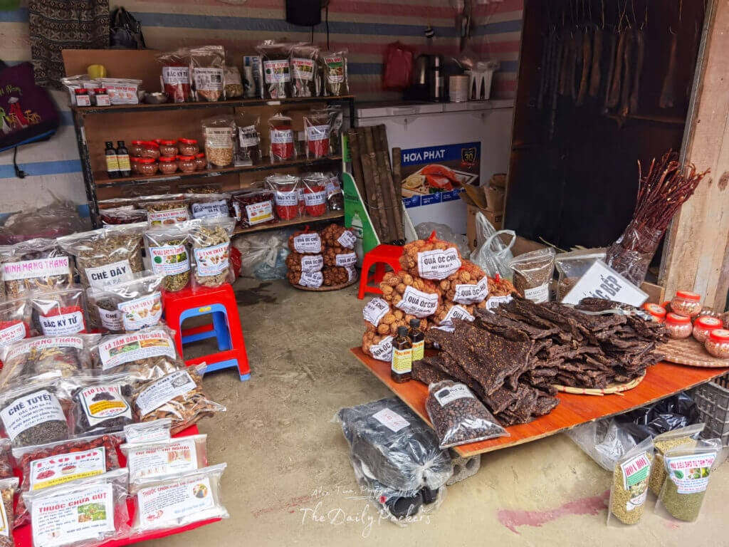 Local market stall selling dried goods, herbs, and traditional snacks in Cat Cat Village.