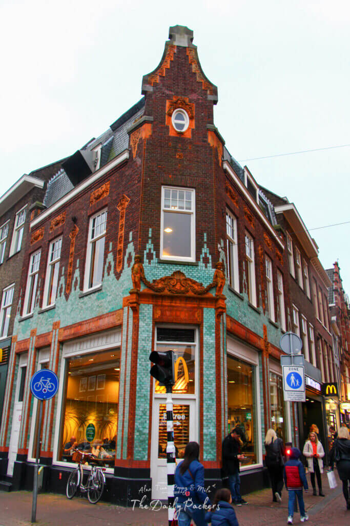 Historic Dutch building in Haarlem with ornate brickwork and a McDonald’s on the corner