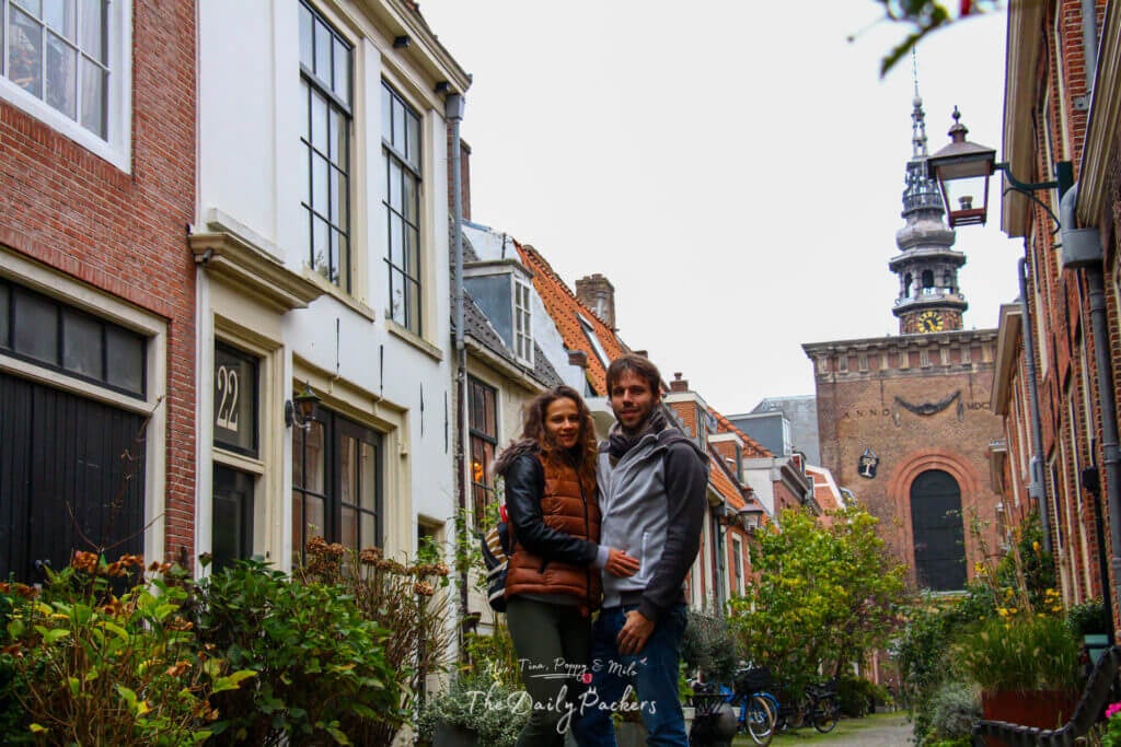 Couple standing together in a quiet street in Haarlem with a church tower behind them