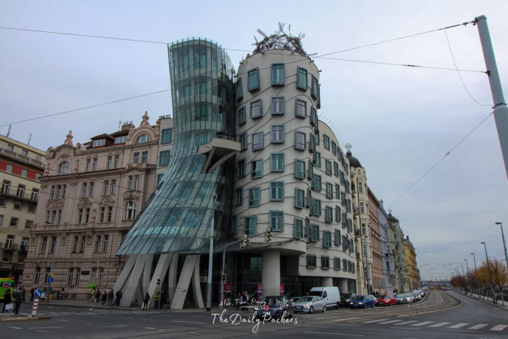 View of the Dancing House in Prague, a modern architectural landmark with its iconic curving glass and stone structure.