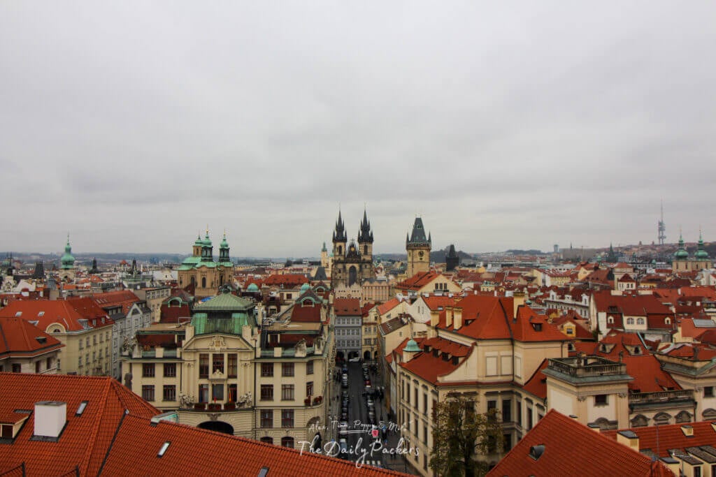 Panoramic view over the red rooftops of Prague’s Old Town with the Týn Church and Old Town Hall rising in the center.