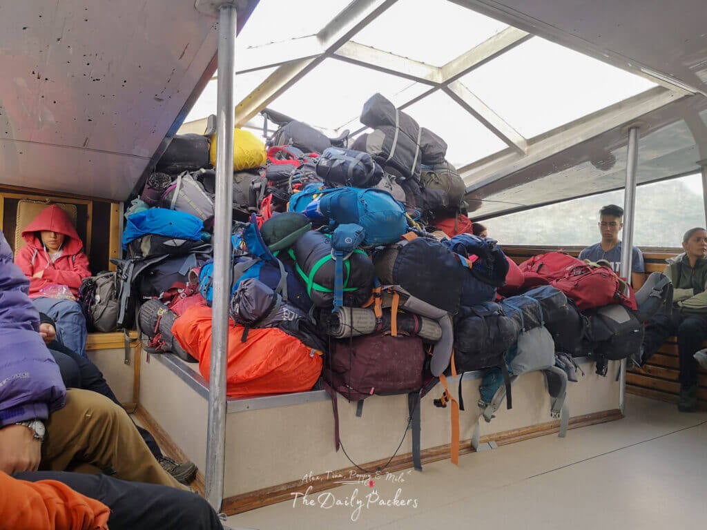 Backpacks piled high inside the ferry as passengers sit around during the crossing in Torres del Paine.