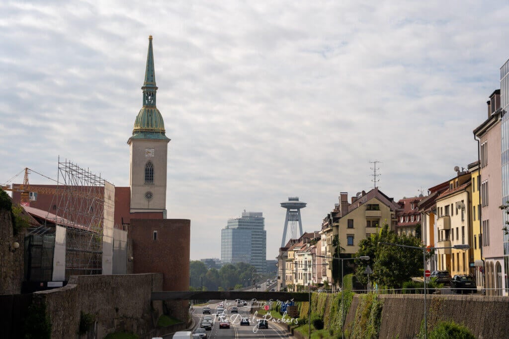 St. Martin’s Cathedral with the UFO Bridge and city skyline in the background, seen from Bratislava’s highway.