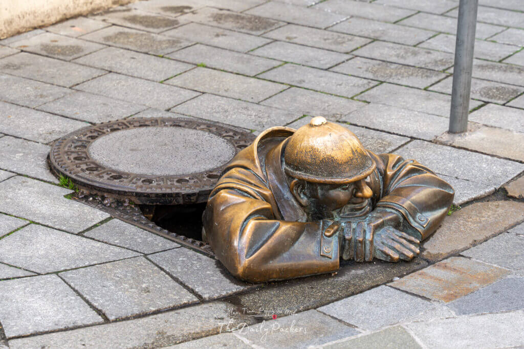 Statue of Čumil, the famous bronze man peeking out of a manhole in Bratislava’s Old Town.