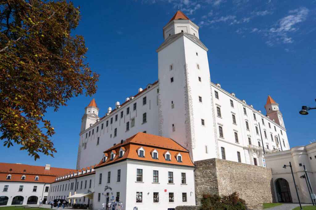 Bratislava Castle with its four towers viewed from below on a sunny day with blue sky