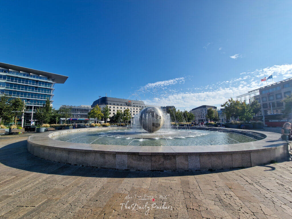 Planet of Peace Fountain in front of modern buildings at Hodžovo Square in Bratislava