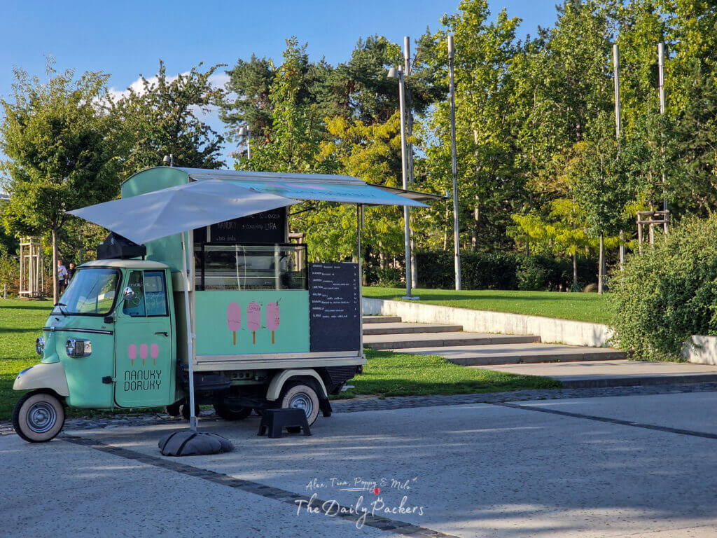Mint-green ice cream truck with a large umbrella parked at Freedom Square in Bratislava