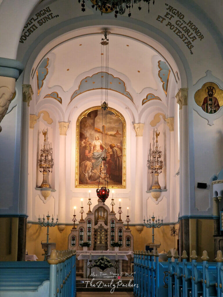 Interior of Bratislava’s Blue Church with ornate altar, chandeliers, and religious paintings