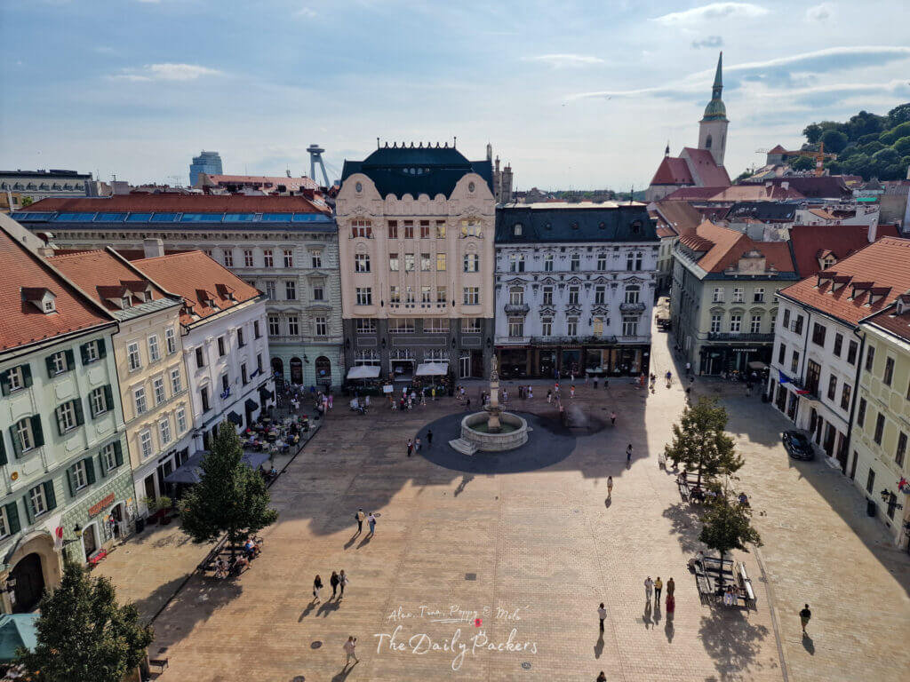Main Square in Bratislava with Roland Fountain, surrounded by historic buildings and lively cafés.