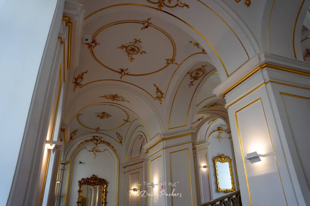 Ornate white and gold decorated ceiling with arches and intricate detailing inside Bratislava Castle.