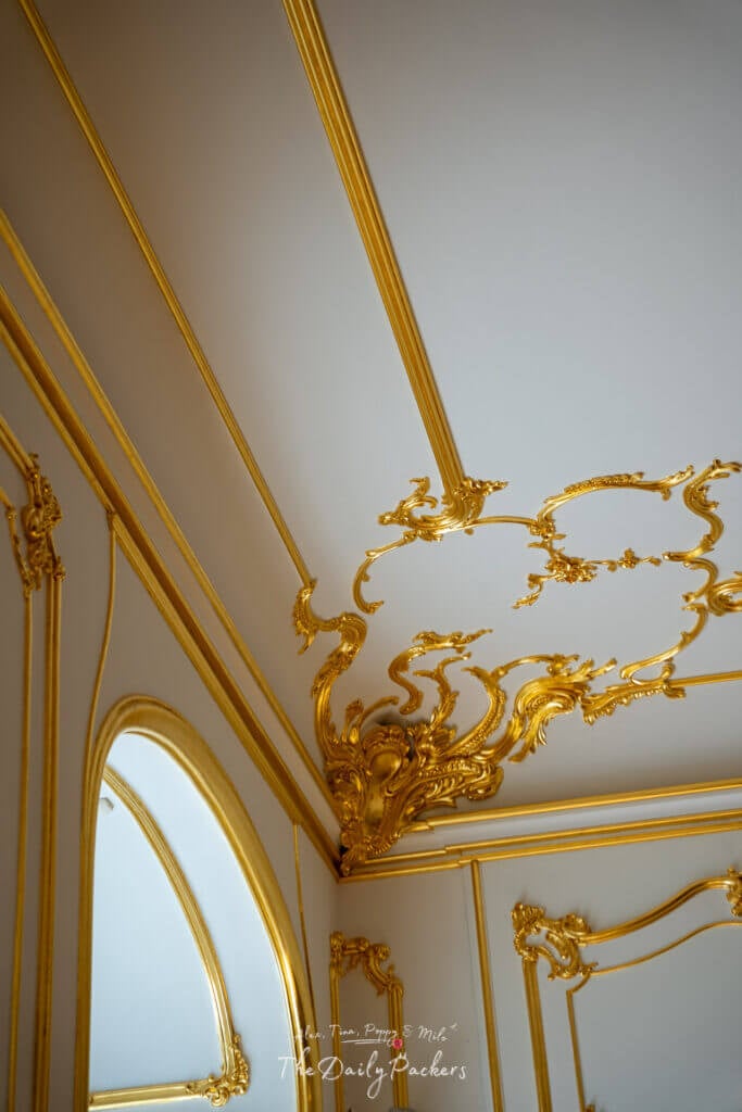 Close-up of golden baroque ceiling details with ornate designs inside Bratislava Castle.