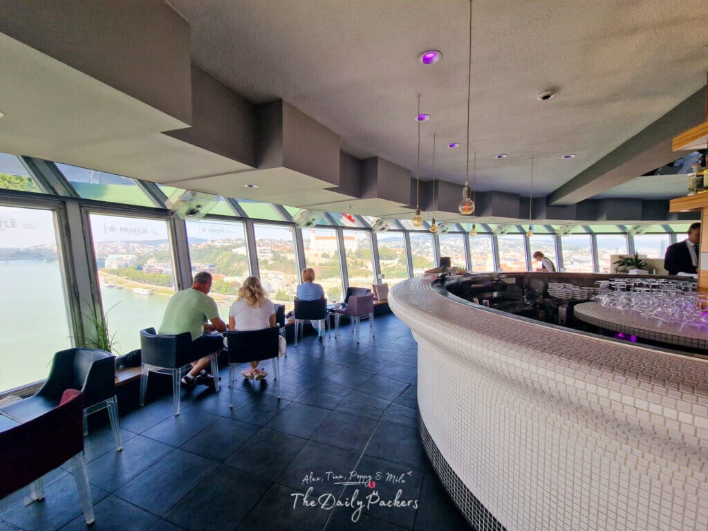 Interior of the UFO Tower restaurant in Bratislava with panoramic windows overlooking the Danube and Old Town.