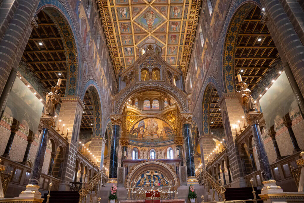 View of the ornate golden altar and painted ceilings inside Pécs Cathedral.