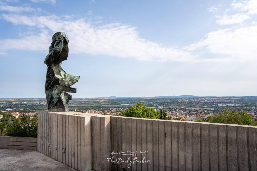Bronze Nike Statue monument overlooking the city of Pécs with a scenic view of the countryside