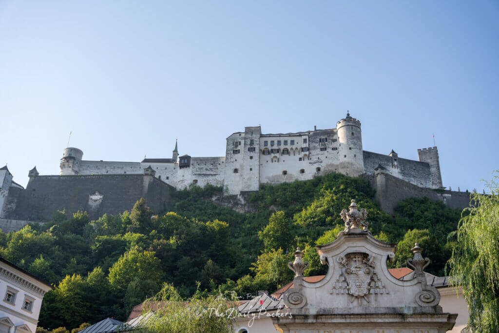 Exterior view of Hohensalzburg Fortress on a clear day with blue sky.