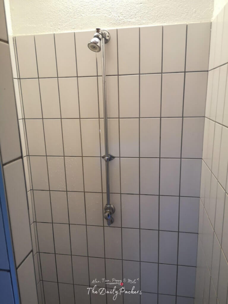 Simple tiled shower at Camping Le Pontet facilities.