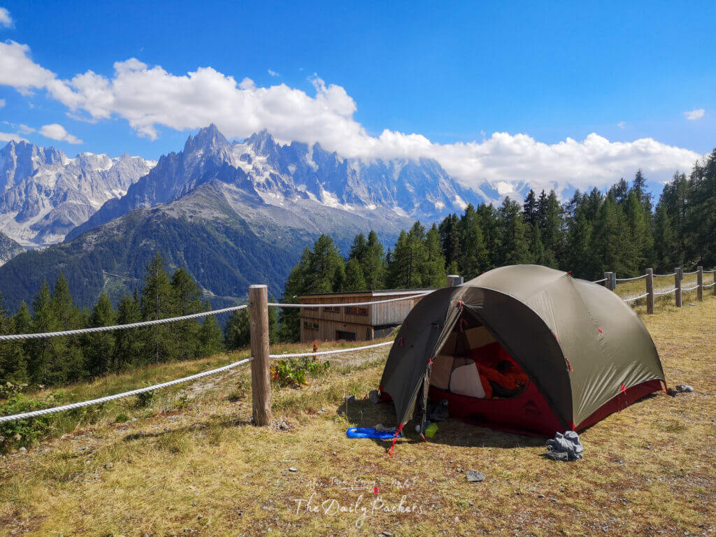 Tent pitched on a fenced viewpoint at La Flégère facing the Aiguilles
