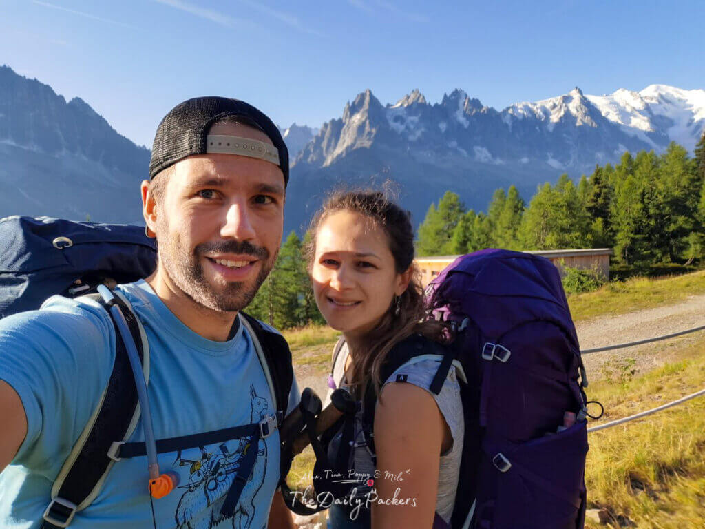 Selfie of two backpackers at La Flégère with the Aiguilles behind.