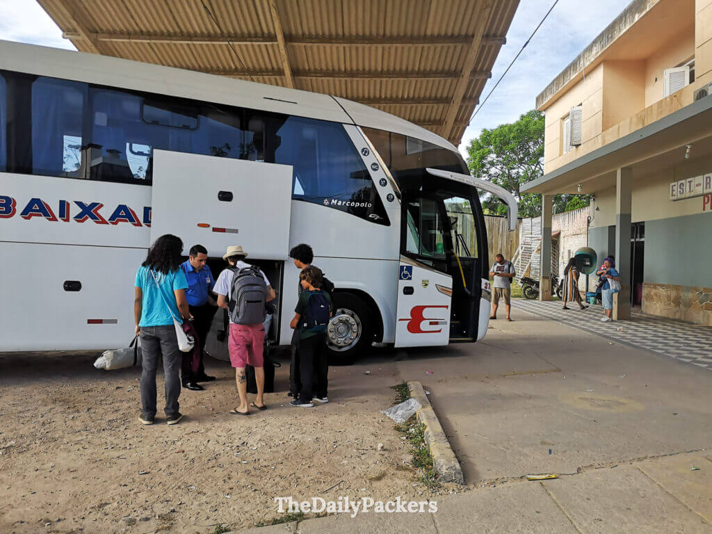 Exterior of the Chuy bus terminal with passengers waiting their luggages from a bus