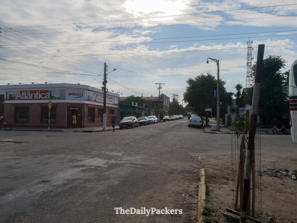Street view of Chuy town near the Brazil–Uruguay border, with low buildings and a corner shop named Atlântica.
