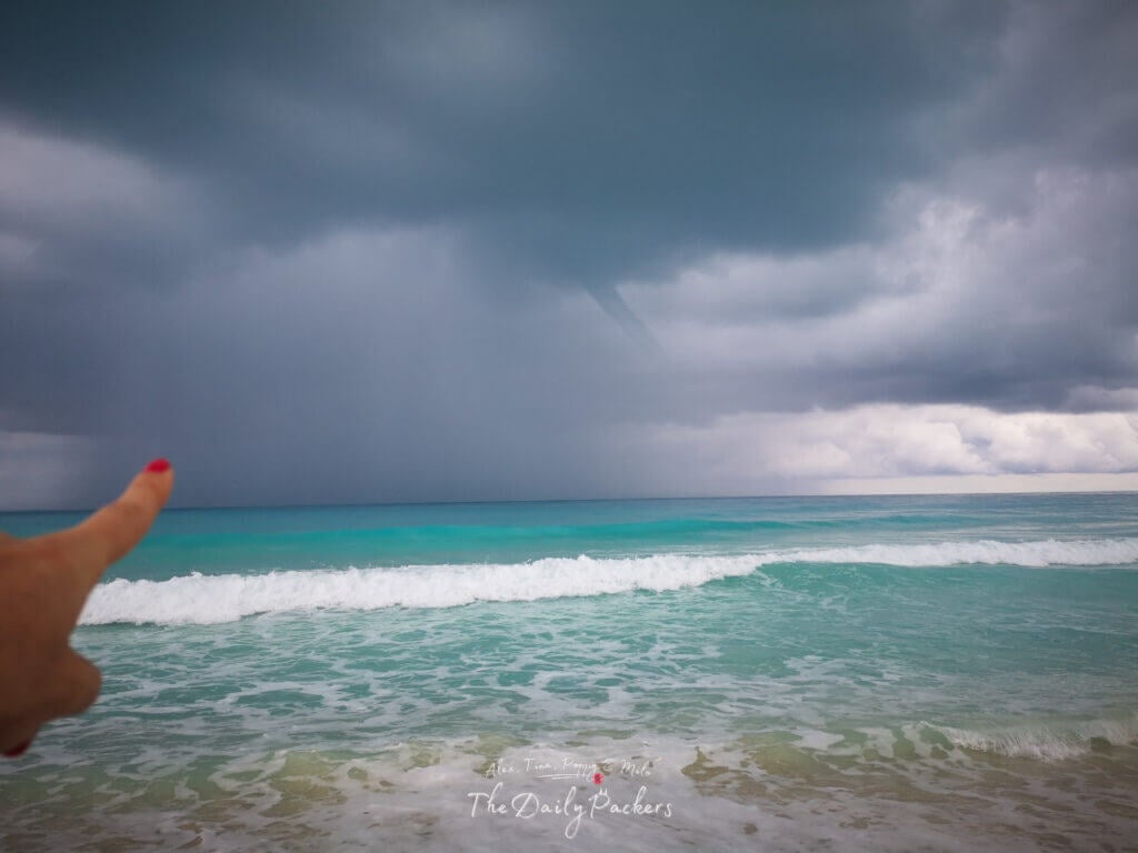 Stormy skies with a visible waterspout over the turquoise sea in Cayo Santa Maria, Cuba.