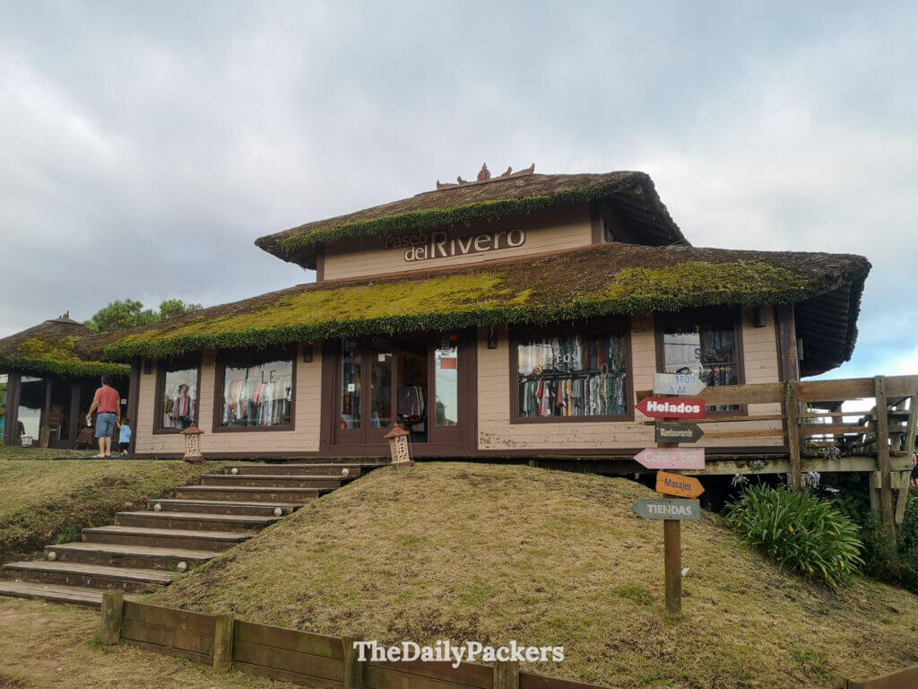 Paseo del Rivero, a charming boutique and café building with a green moss-covered roof in Punta del Diablo.