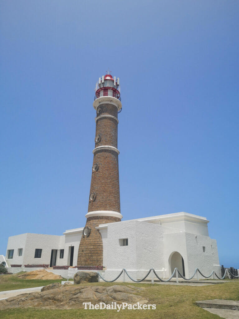 Cabo Polonio Lighthouse rising above the coastline, with its red-and-white lantern and panoramic ocean views.