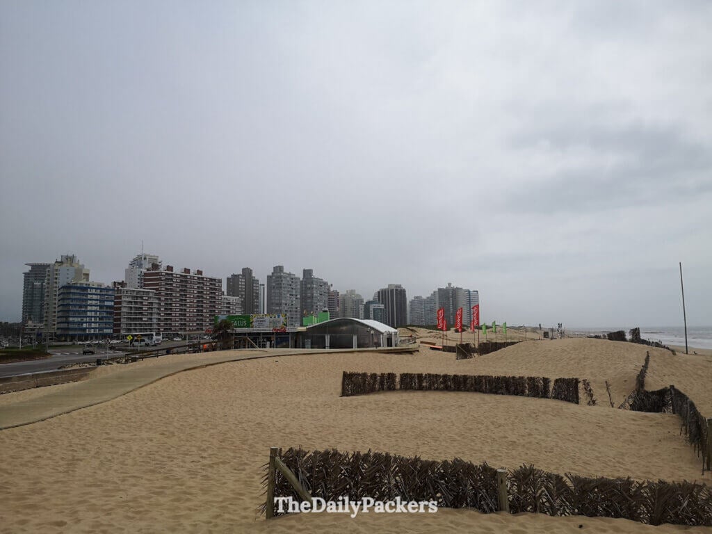 Sandy Playa Brava with city skyscrapers in the background on a cloudy day in Punta del Este.