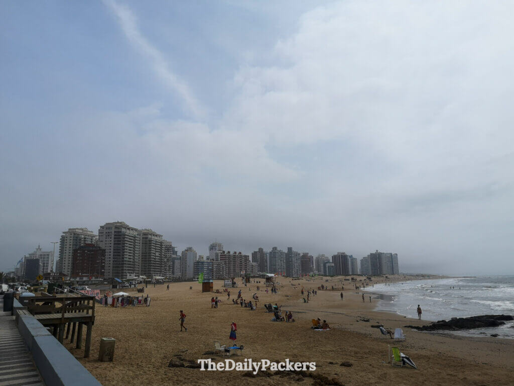 Panoramic view of Punta del Este’s modern beachfront skyline with beachgoers enjoying the sandy shore.