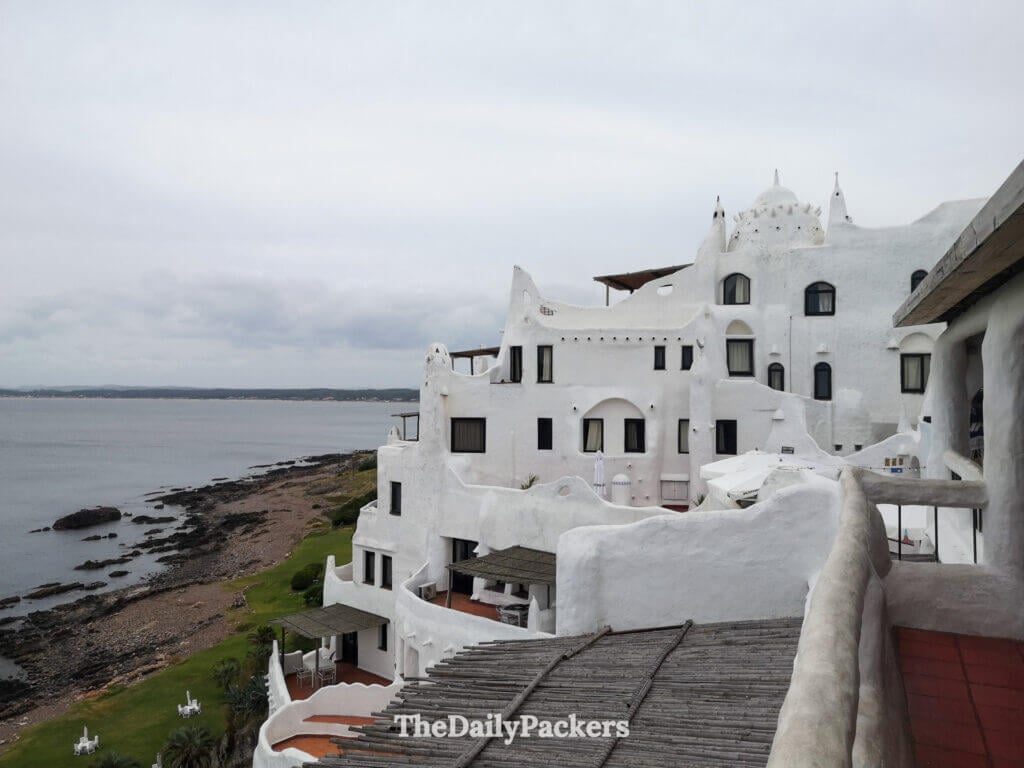 Iconic whitewashed Casa Pueblo overlooking the rocky coastline and calm sea near Punta del Este.