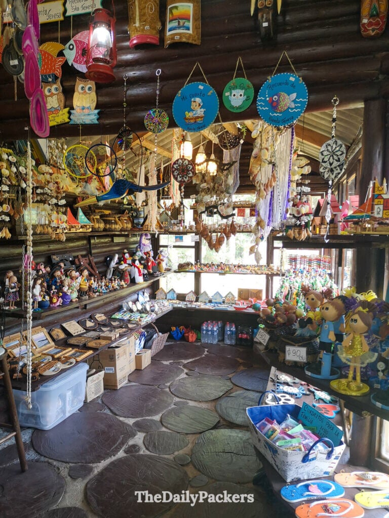 Interior of the Santa Teresa souvenir shop filled with colorful handmade crafts and local trinkets.
