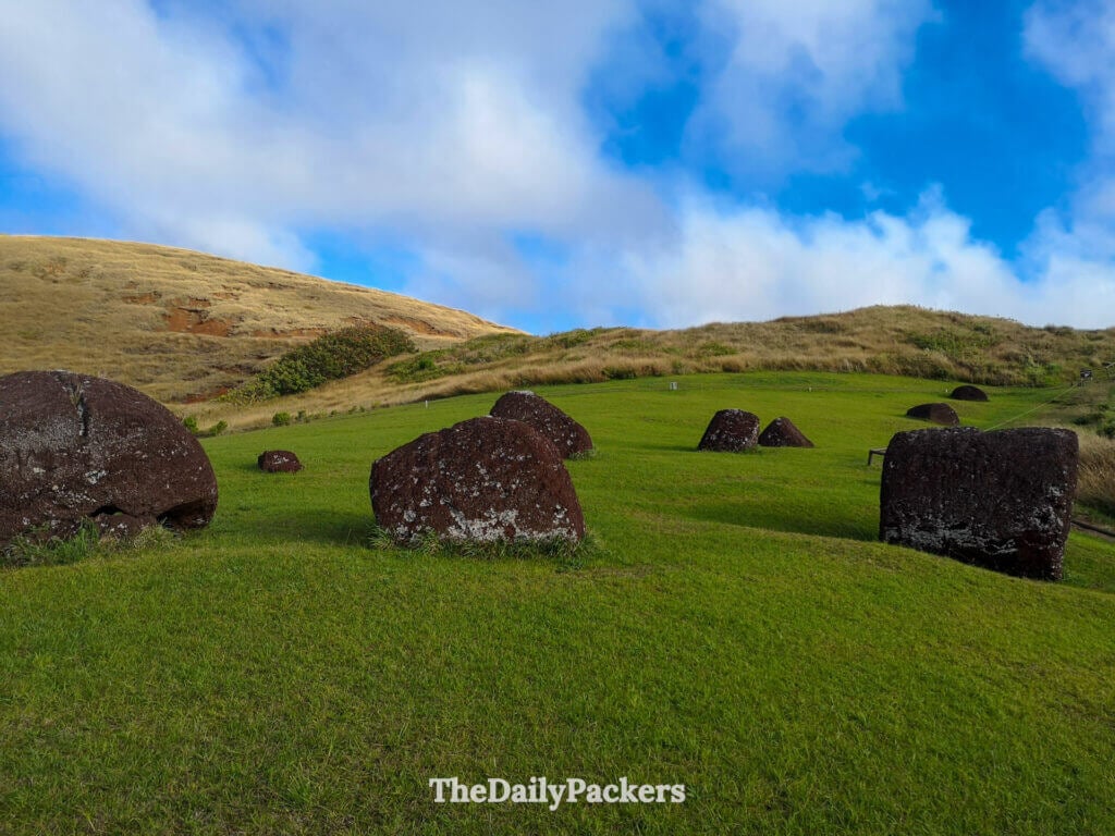 Close-up view of scattered red scoria pukao topknots at Puna Pau, the ancient quarry on Easter Island where the stone hats for the moai were carved.