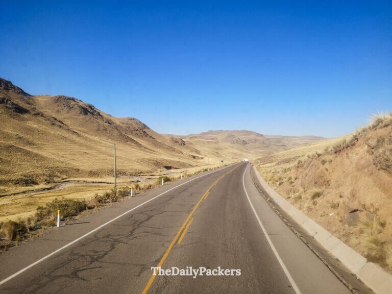 Panoramic view of the Peruvian Altiplano along the Arequipa to Puno route, with vast open land under a deep blue sky