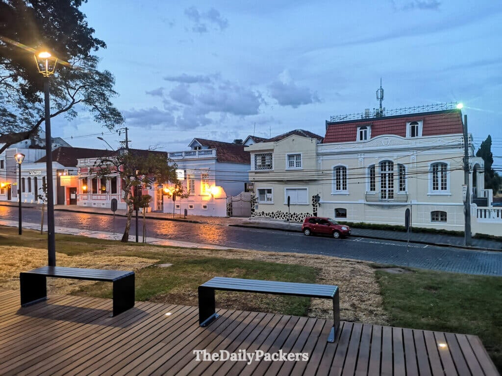 Vue nocturne de la vieille ville de Curitiba avec des maisons coloniales, des rues pavées et des lampadaires chaleureux créant une atmosphère calme