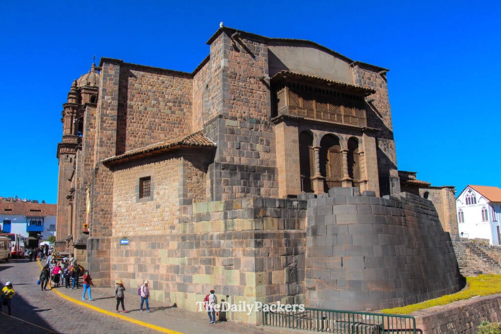 Exterior view of the Santo Domingo Convent in Cusco, Peru, showing Inca stone foundations supporting the Spanish colonial church above.
