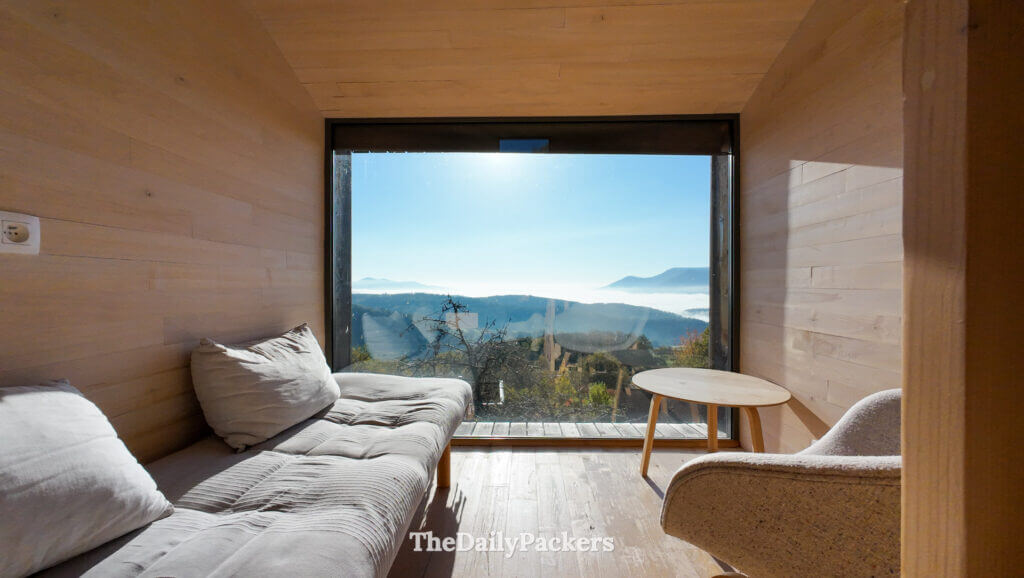 Cozy lounge area with wooden walls and modern design inside a Tre Hytte cabin at 48° Nord Landscape Hotel in Alsace