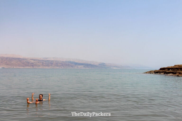 Traveler floating effortlessly on the Dead Sea, demonstrating the extreme buoyancy caused by the high salt concentration
