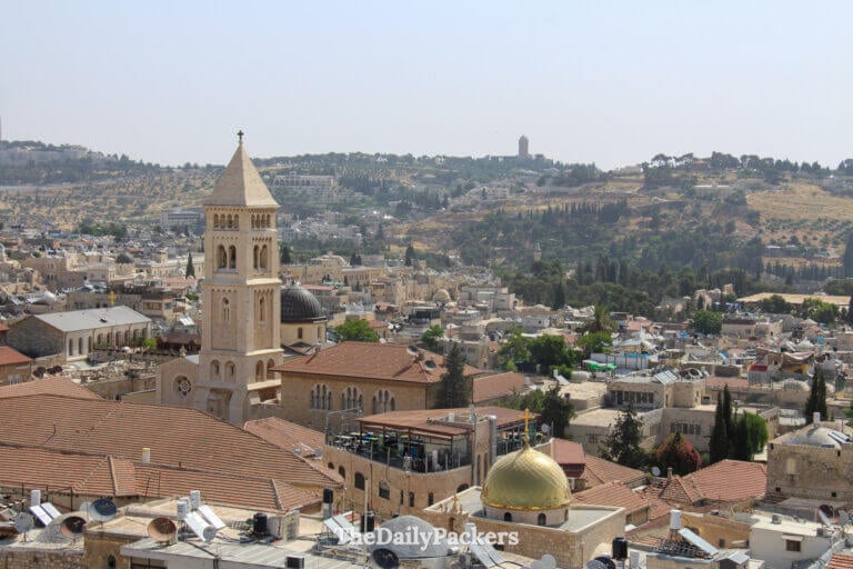 Wide Old City panorama from the Tower of David with historic rooftops, churches, and surrounding Jerusalem hills