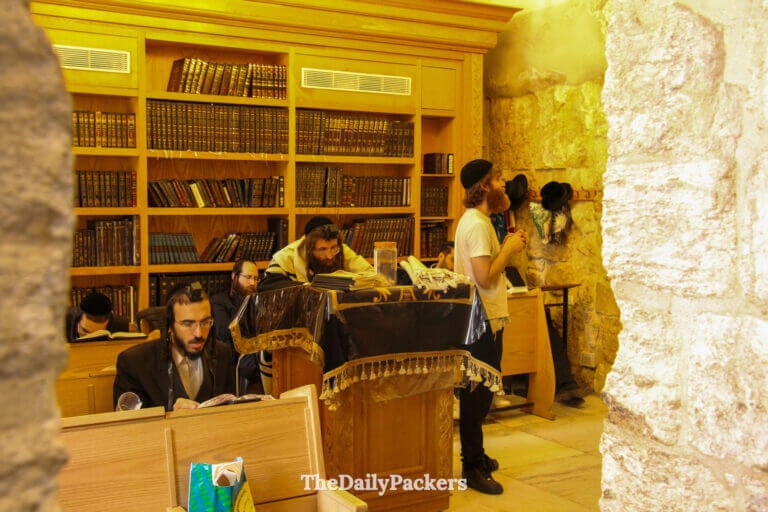 Interior study room near King David’s Tomb in Jerusalem with religious bookshelves and Orthodox Jewish men studying sacred texts